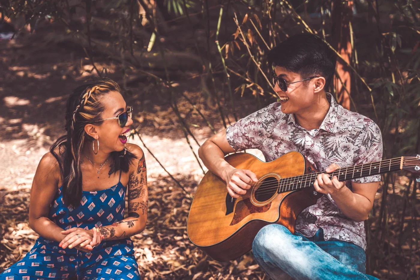 NyaLi and Ze outdoors, singing and playing acoustic guitar together
